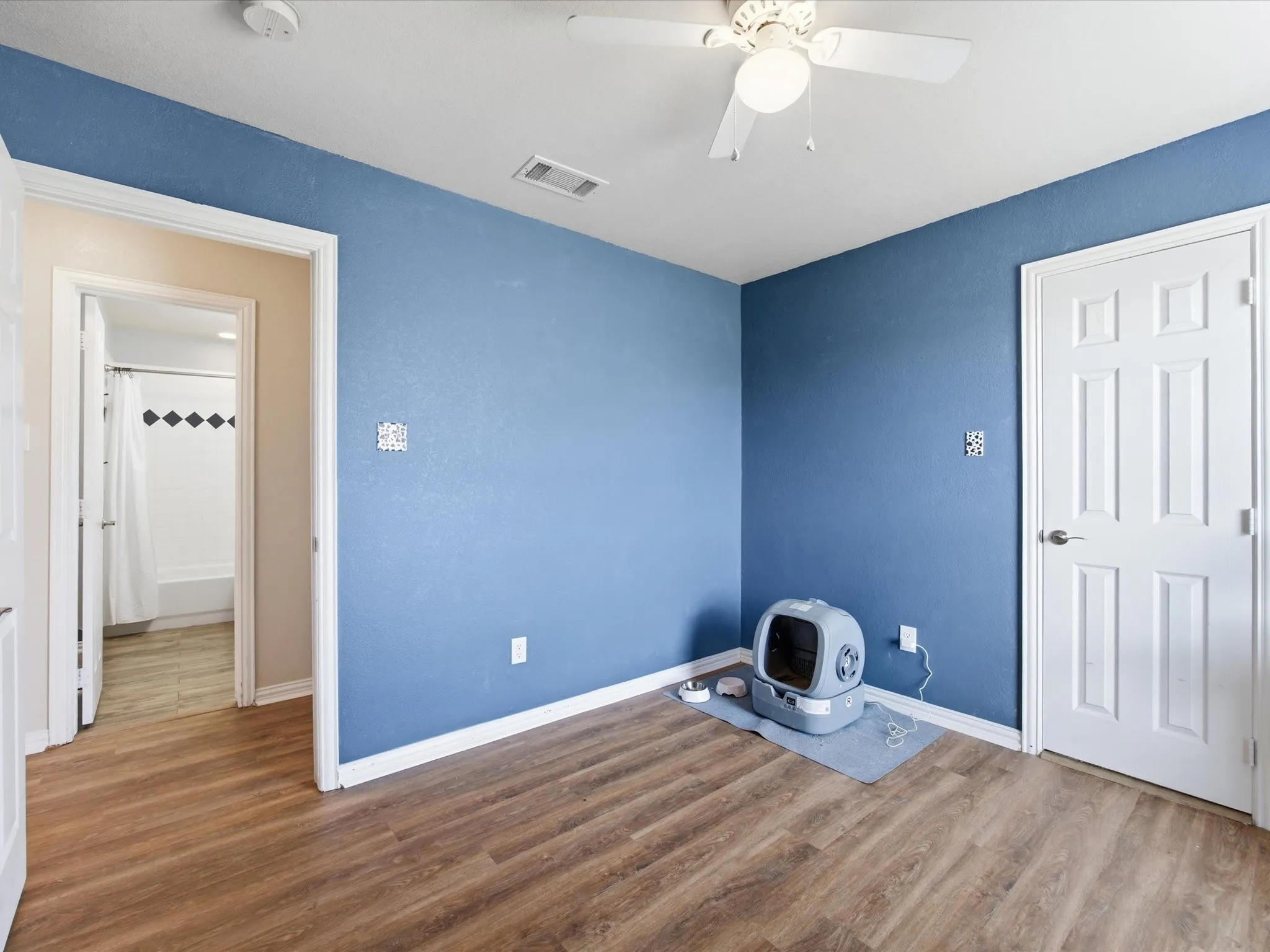 Unfurnished bedroom featuring wood finished floors and a ceiling fan