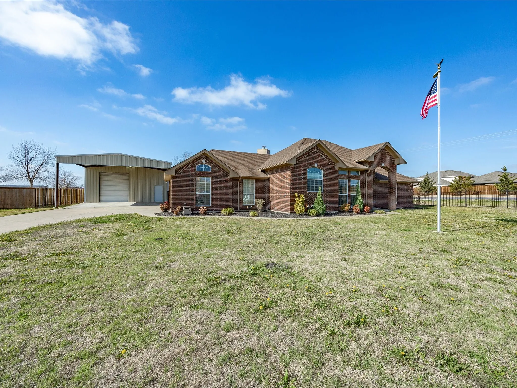 Single story home with brick siding, a garage, a chimney, and concrete driveway
