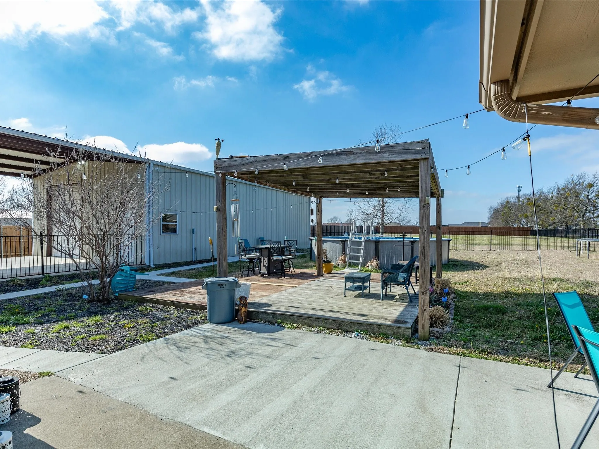 Fenced backyard featuring a deck and a patio area
