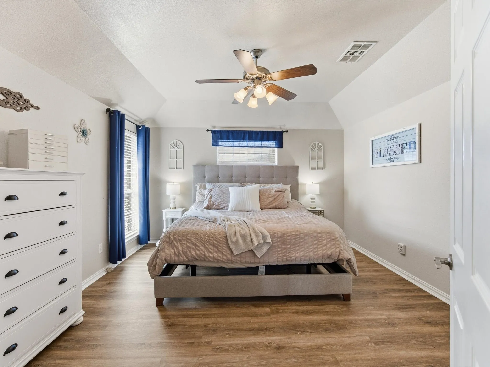Master Bedroom featuring wood finished floors, vaulted ceiling, and a ceiling fan