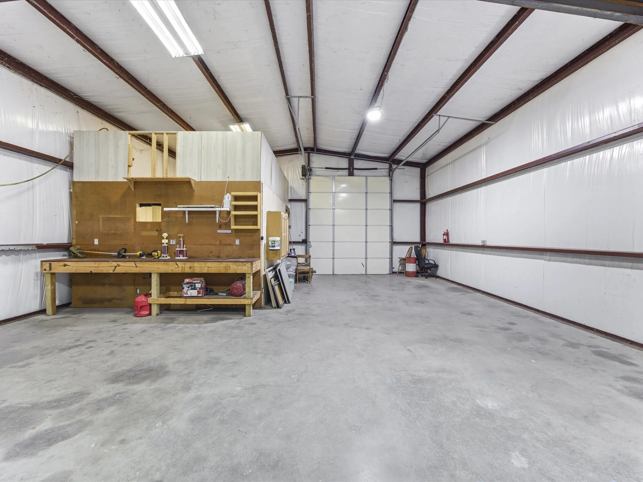 Detached shop featuring a workshop area and metal wall
