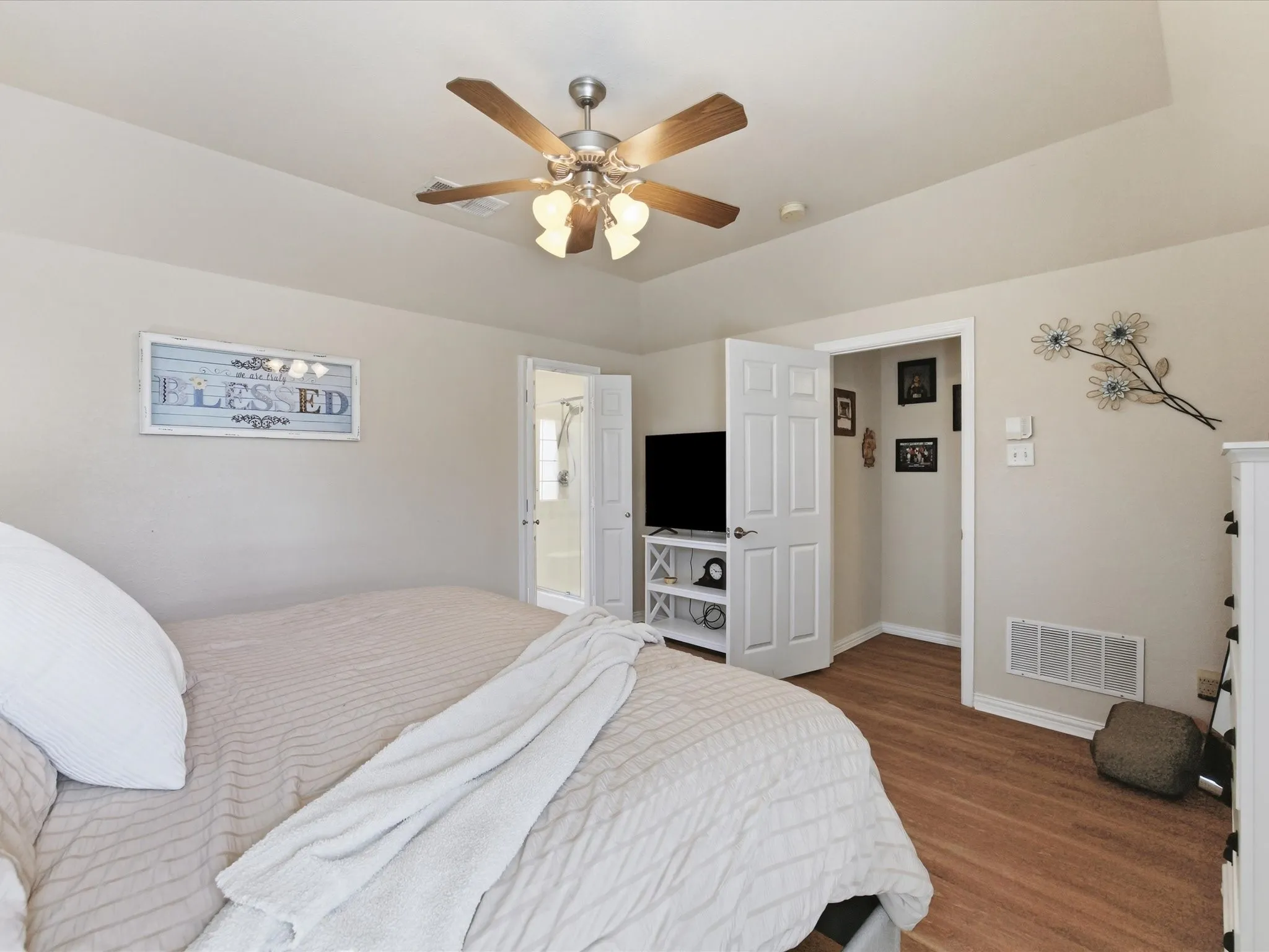 Master Bedroom featuring ceiling fan, wood finished floors, and connected bathroom