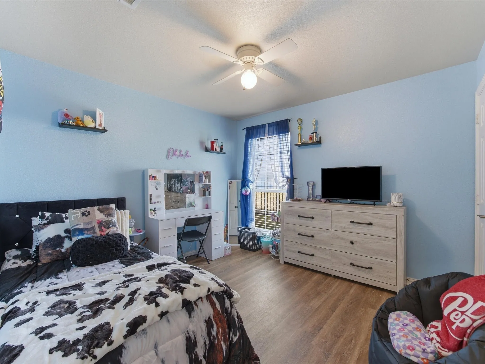 Bedroom with dark wood-style flooring and ceiling fan
