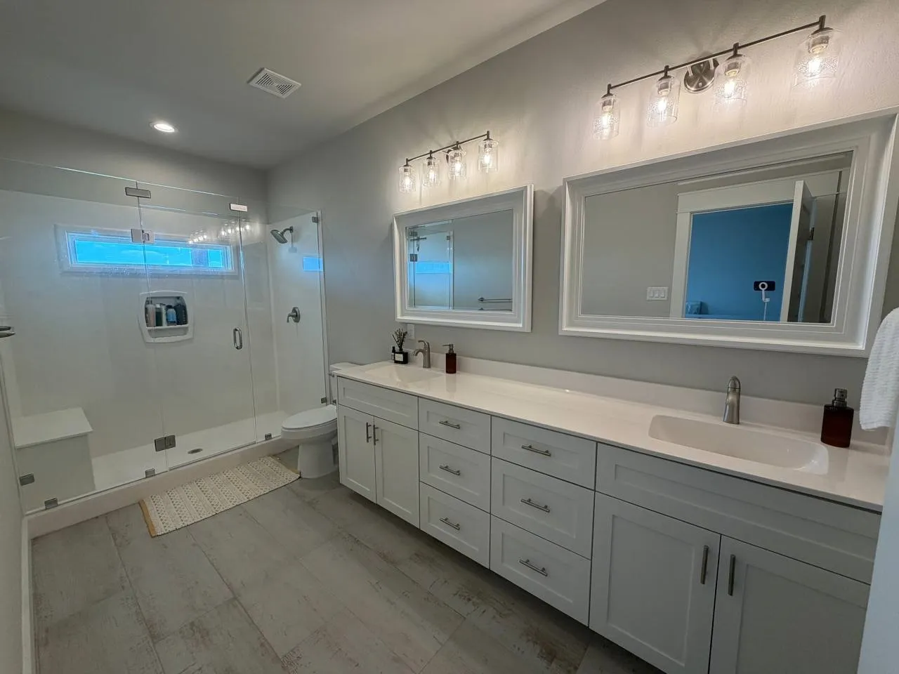 Bathroom featuring double vanity, a stall shower, and recessed lighting