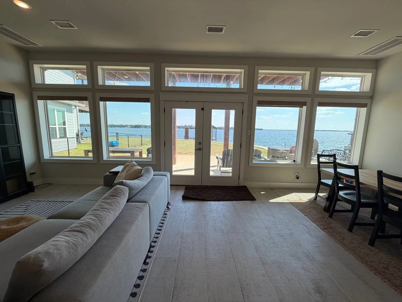 Doorway featuring a water view, french doors, and tile floors.
