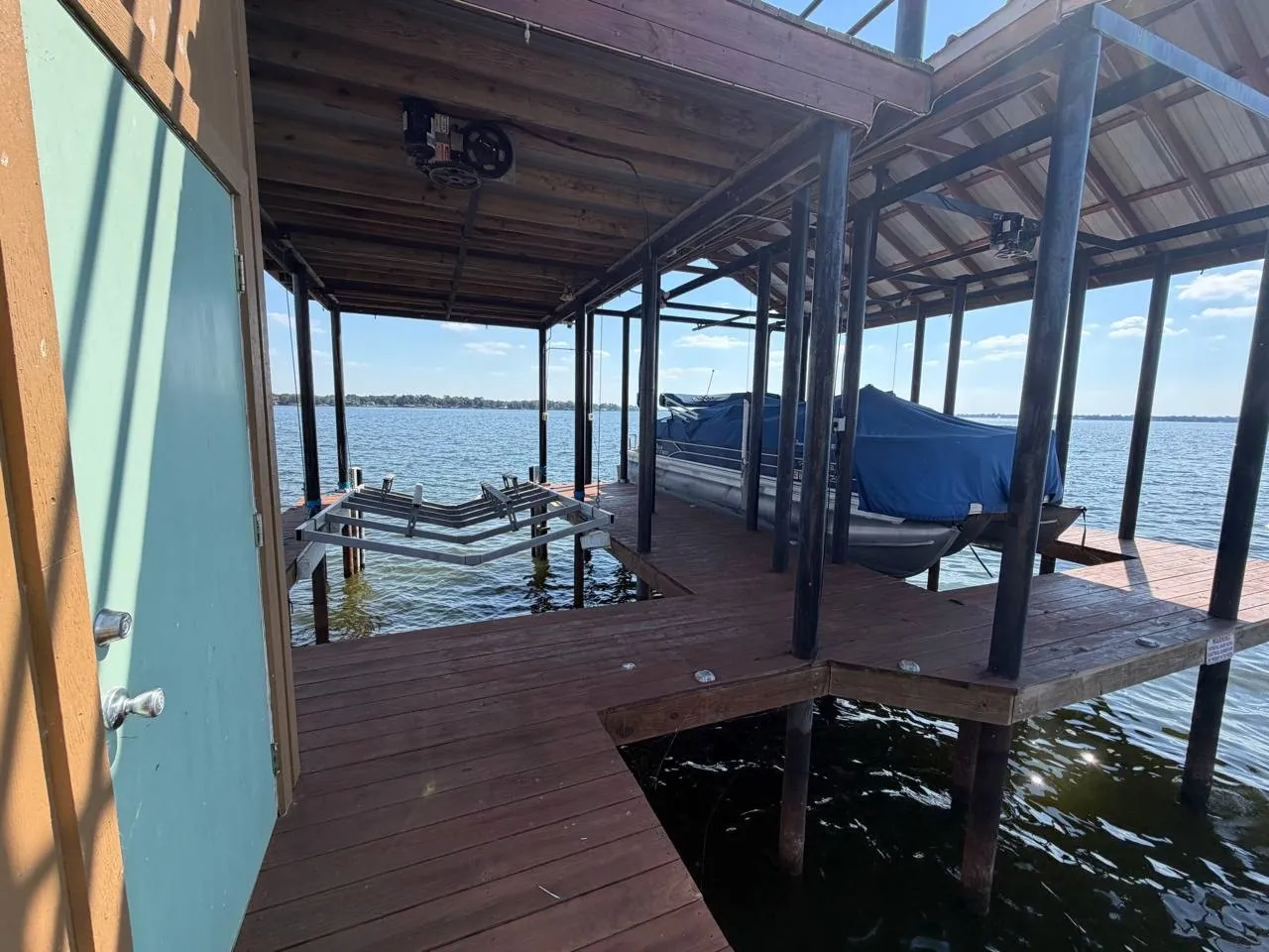 Dock featuring boat lift and a water view
