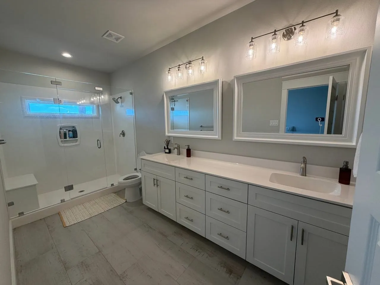 Bathroom featuring double vanity, a stall shower, and recessed lighting