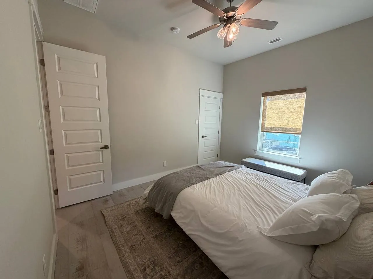 Bedroom with light wood-style flooring and a ceiling fan