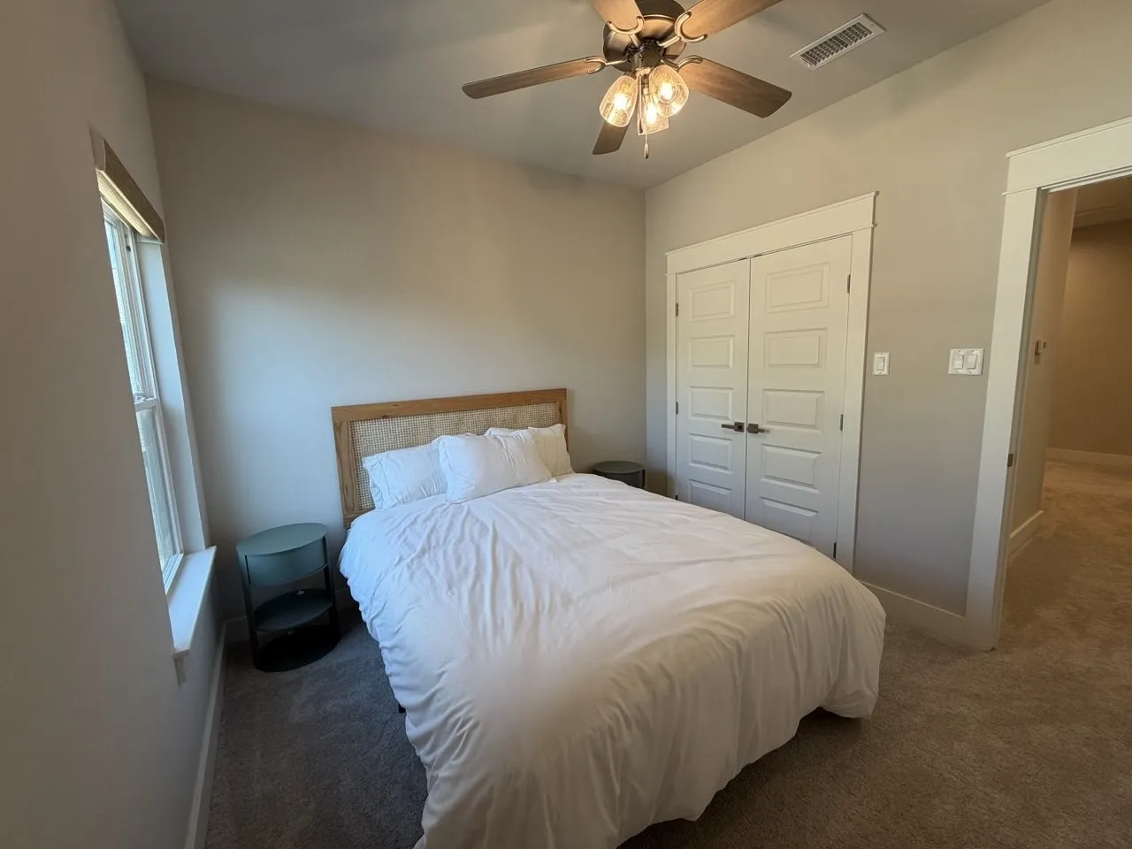 Carpeted bedroom featuring a closet and ceiling fan