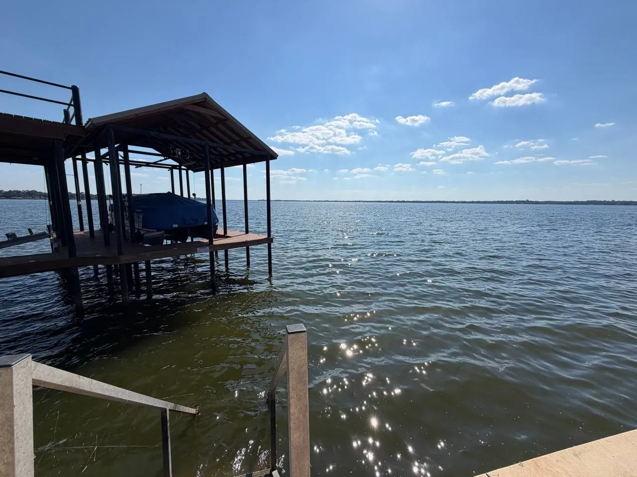 Dock area with a water view and boat lift