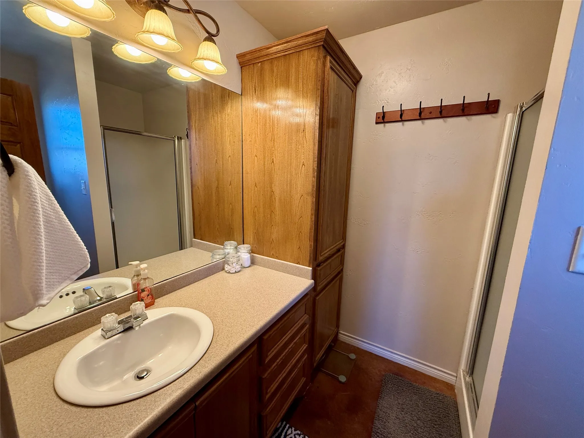 Bathroom featuring vanity and a shower stall