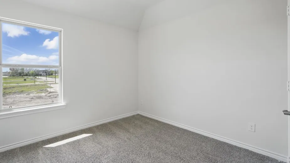 Inviting room featuring a double-hung window, light gray carpet, white baseboards, and a neutral wall color