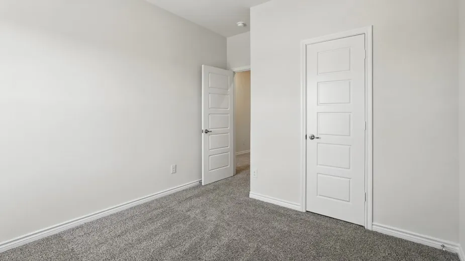 Neutral-toned interior with soft gray carpeting and white baseboards
