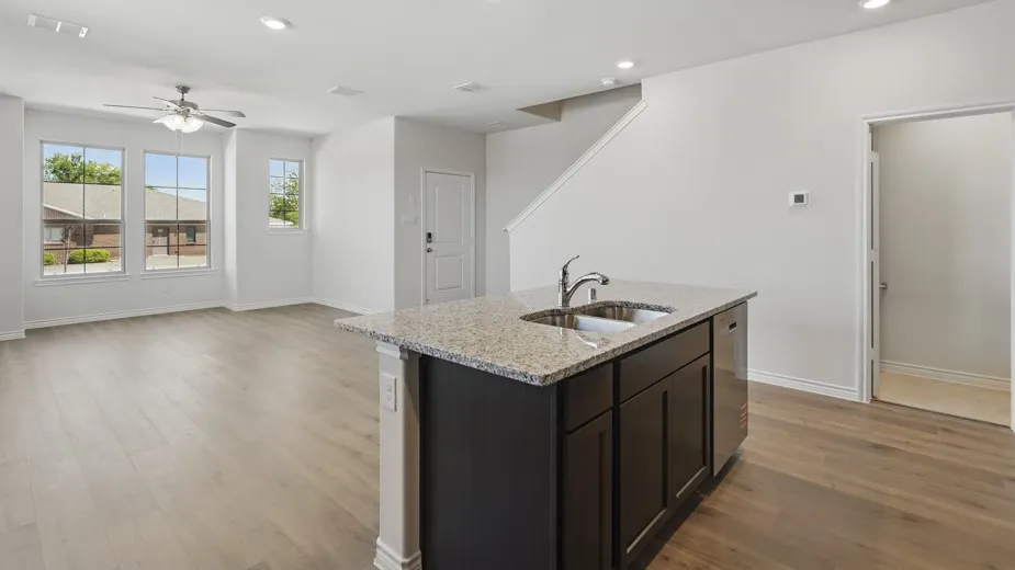 Open-concept living space featuring wood-finish flooring, recessed lighting, and a ceiling fan