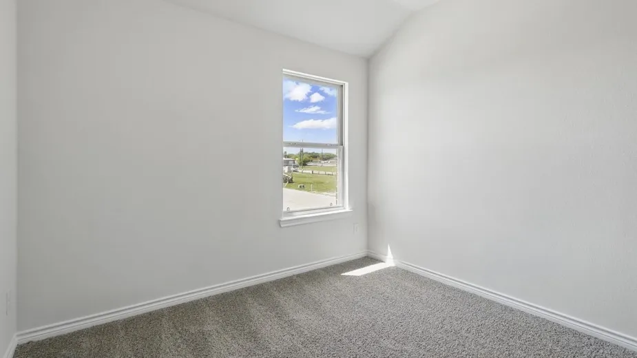 Room featuring a single-pane window, neutral wall paint, and gray carpet flooring