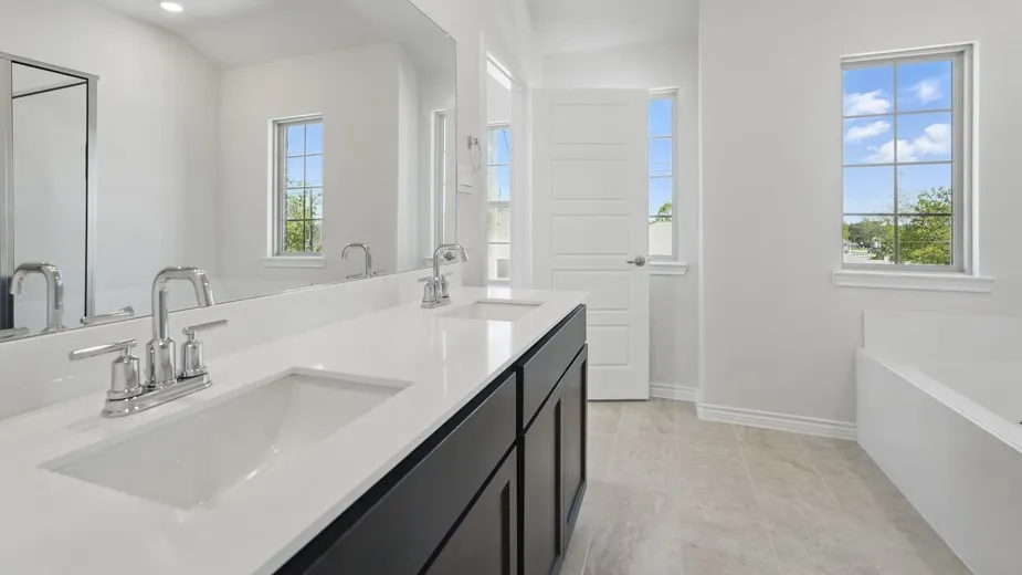 Dual vanity with undermount sinks, chrome fixtures, and a white countertop