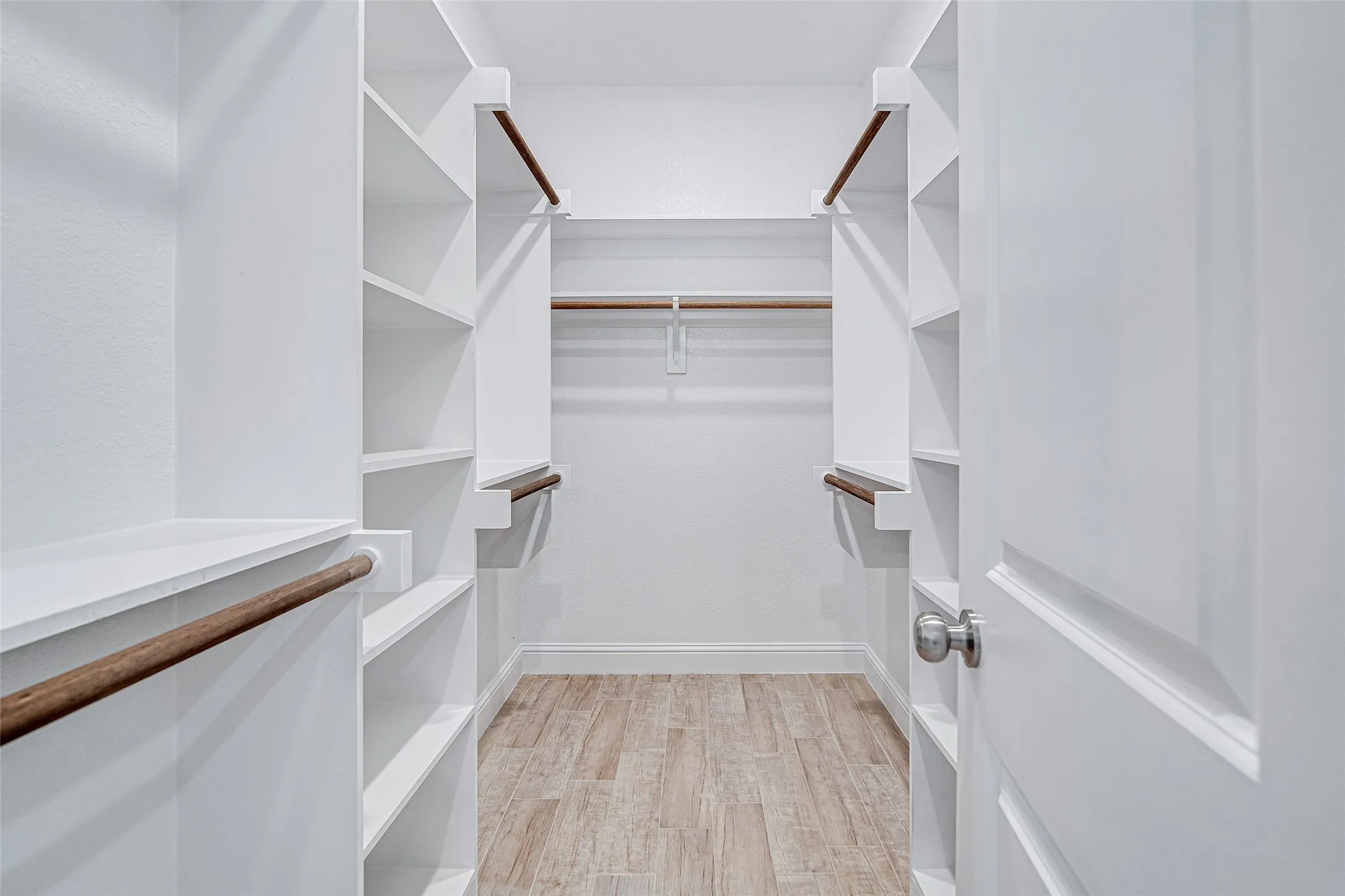 Spacious closet featuring light wood-type flooring