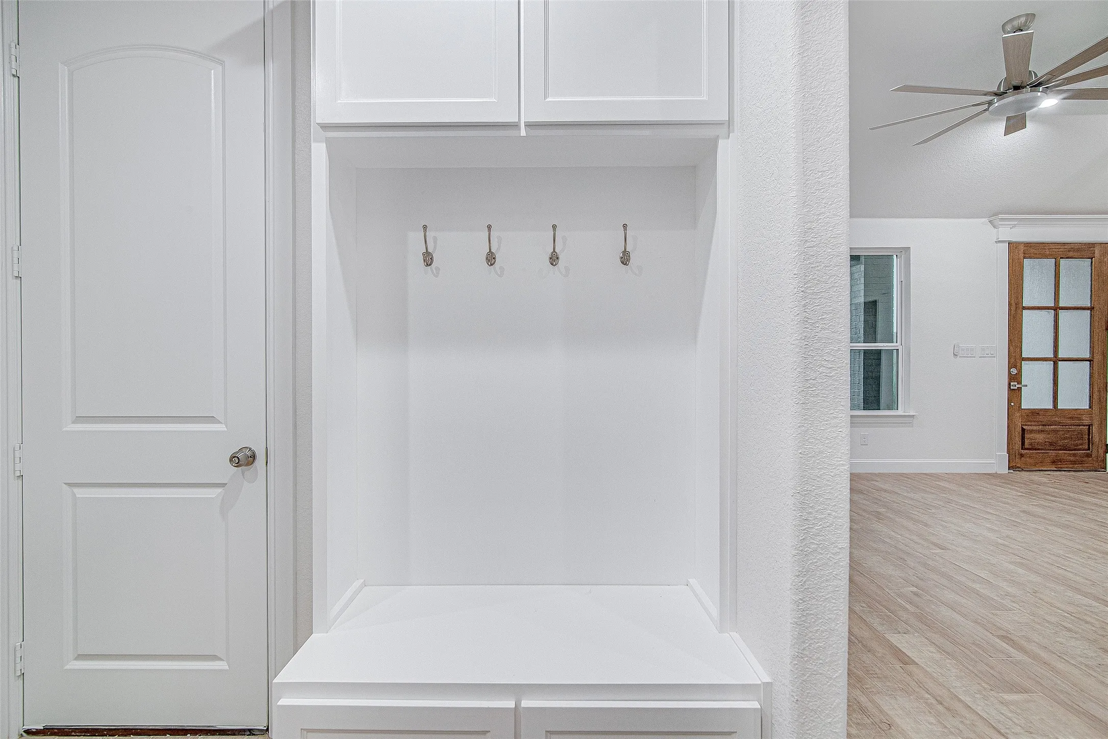 Mudroom featuring a ceiling fan, wood finished floors, and baseboards