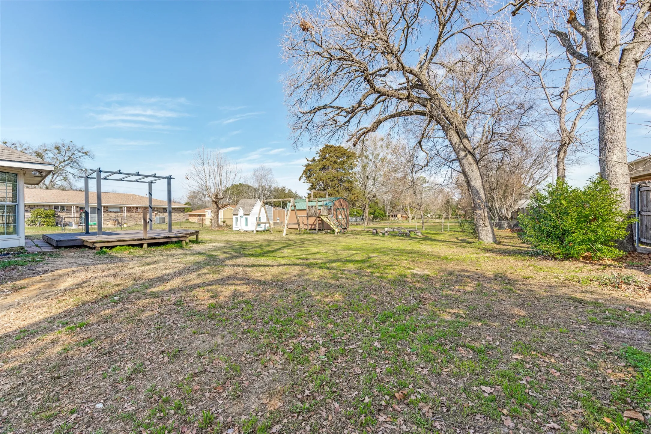 View of yard featuring a playground and a wooden deck
