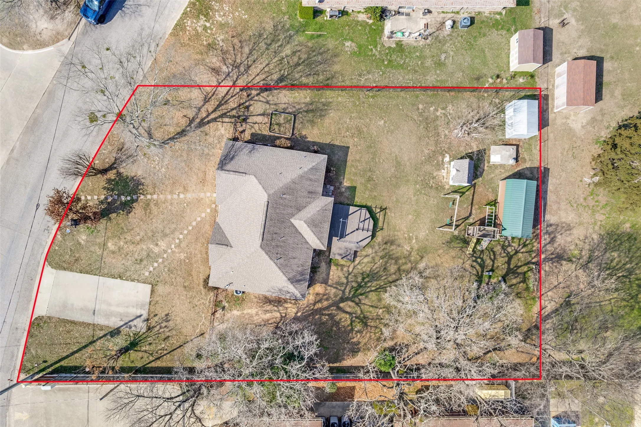 Aerial view of property and surrounding area with property parcel outlined