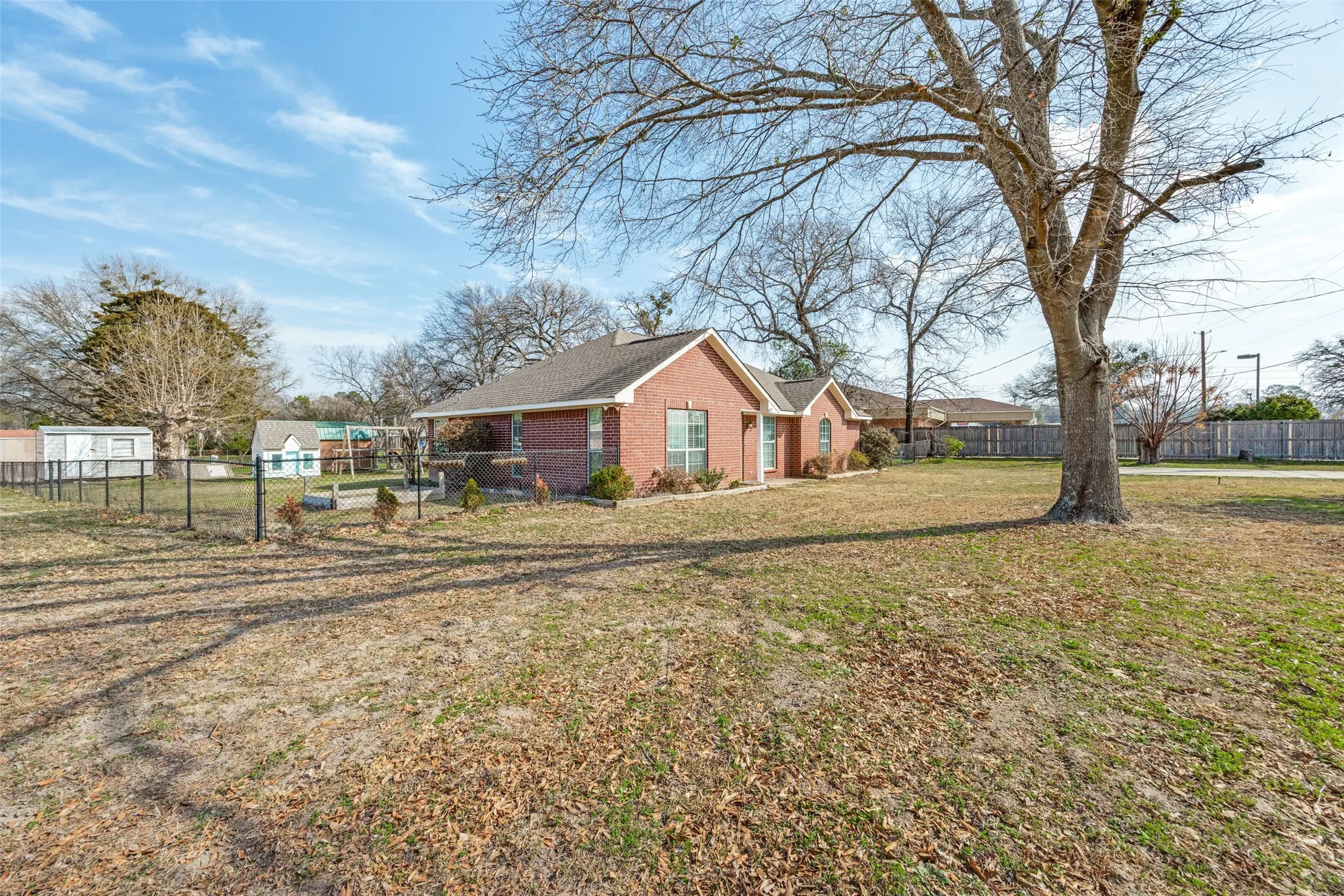 View of side of property featuring brick siding