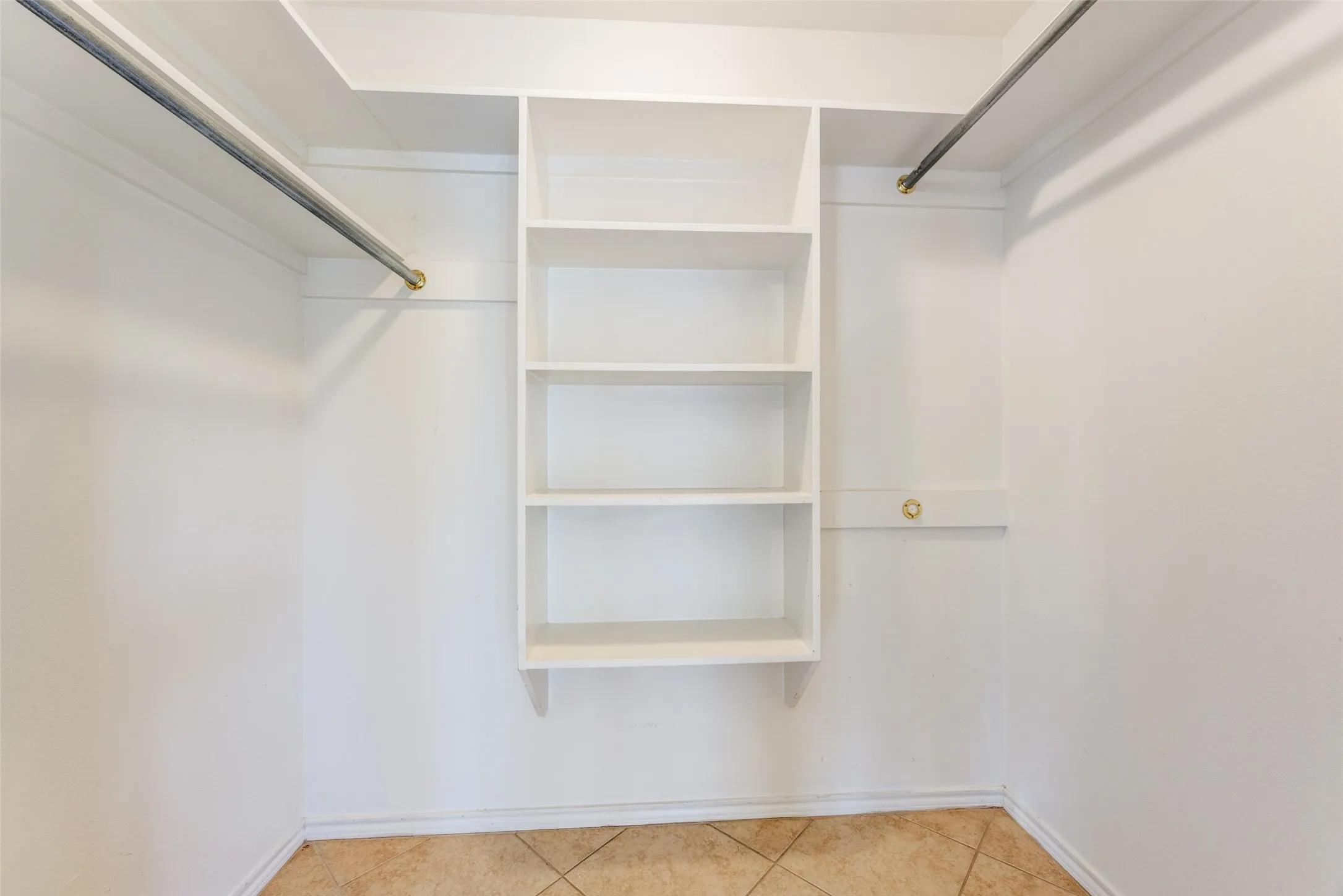 Walk in closet featuring light tile patterned floors
