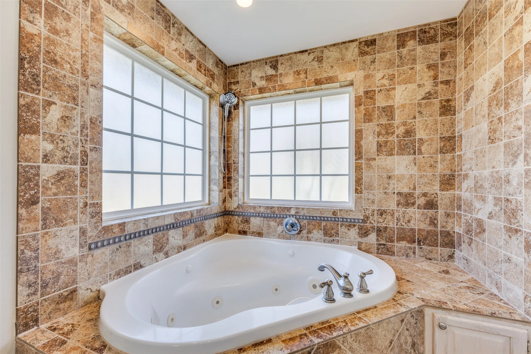 Full bathroom with a whirlpool tub