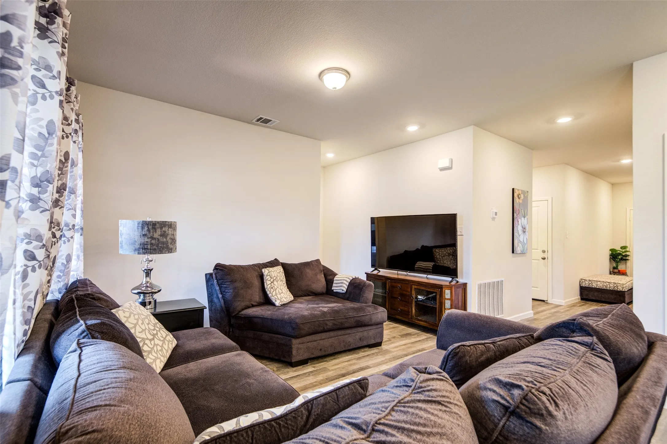Living room featuring wood finished floors and recessed lighting
