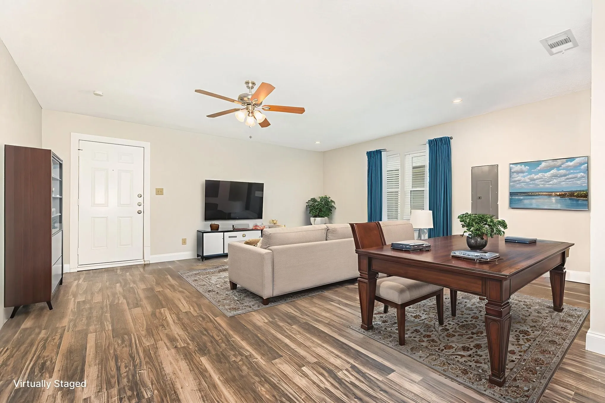 Virtually staged-Living room with a ceiling fan, dark wood finished floors, electric panel, and recessed lighting