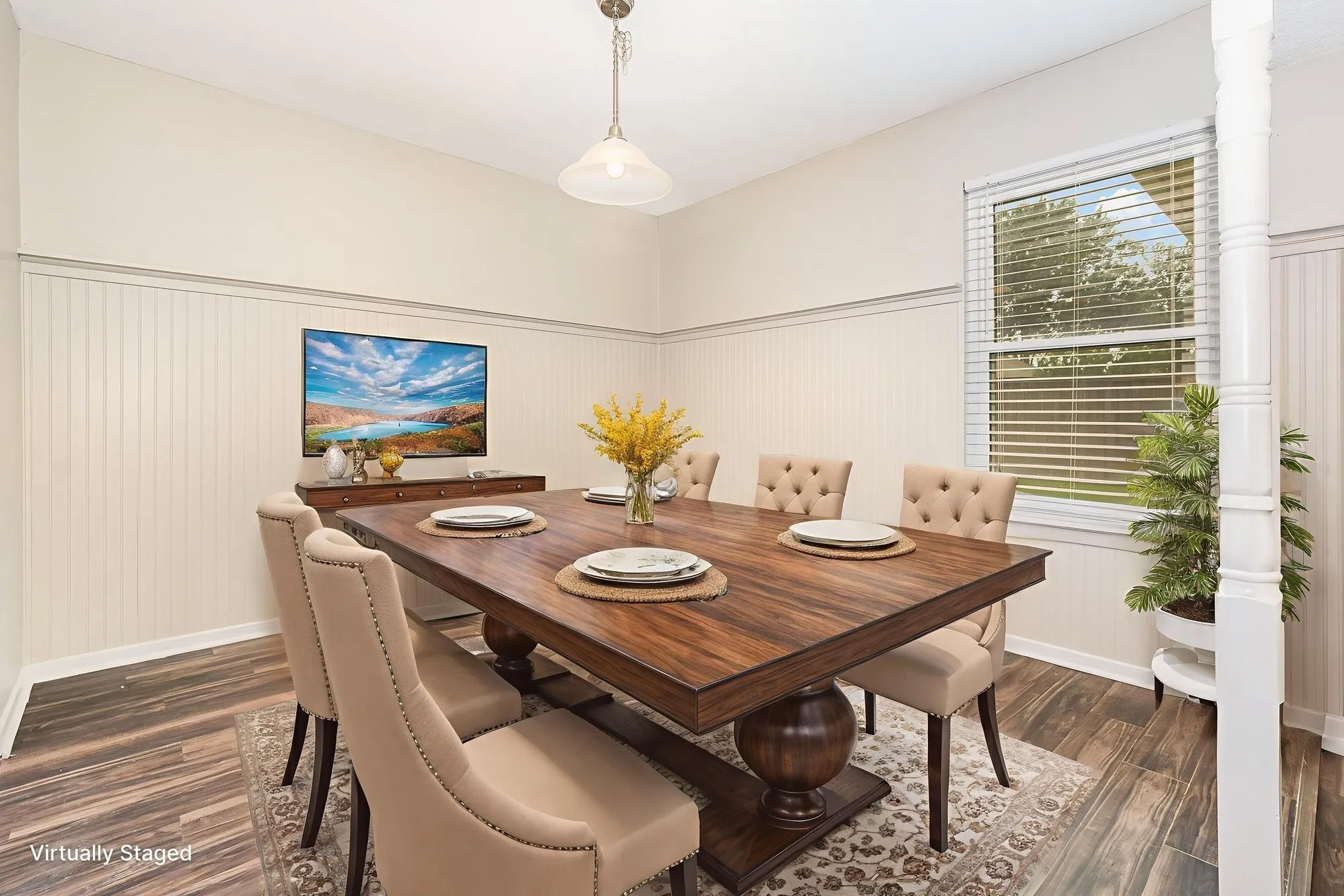 Virtually staged-Dining area with dark wood-type flooring and wainscoting