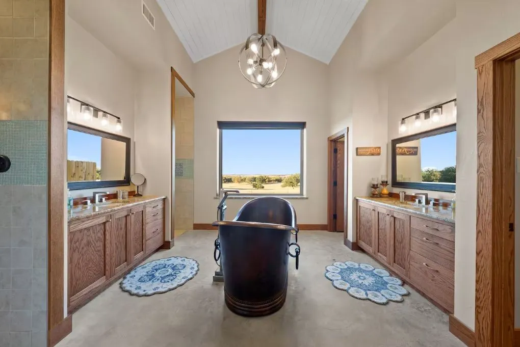 Full bathroom featuring two sinks, vanity, healthy amount of natural light, high vaulted ceiling, and beam ceiling