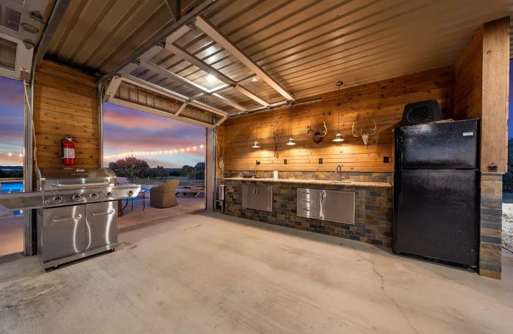 View of patio with exterior kitchen and a sink