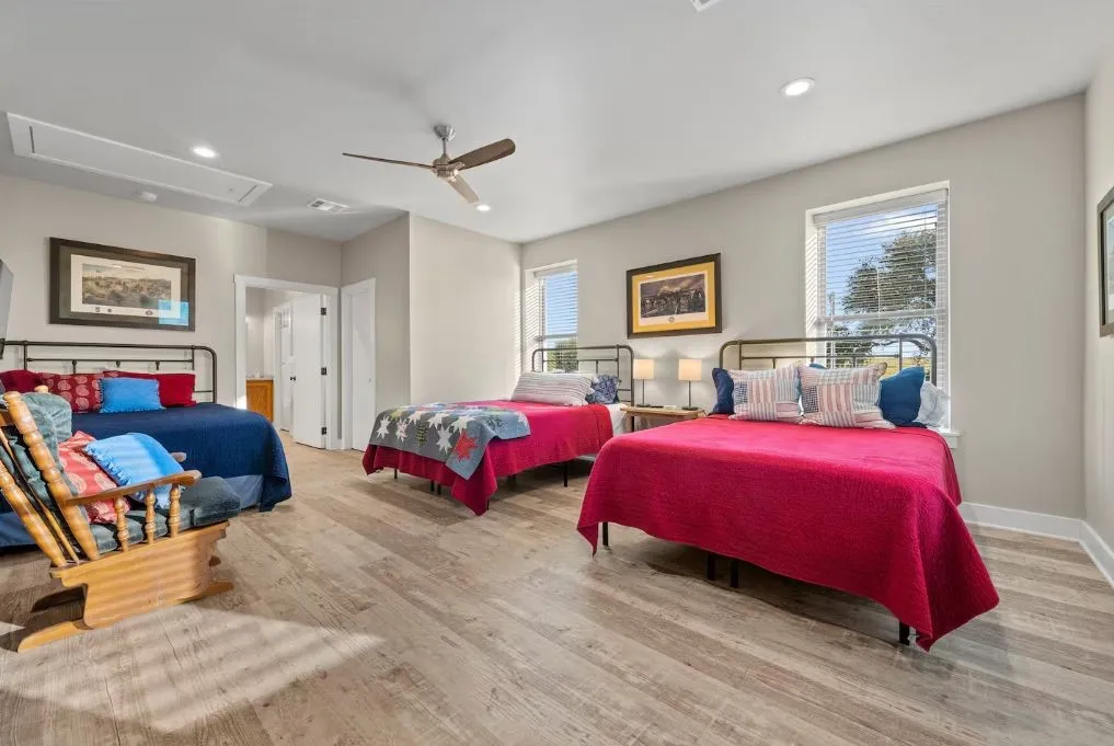 Bedroom featuring attic access, multiple windows, recessed lighting, ceiling fan, and light wood finished floors