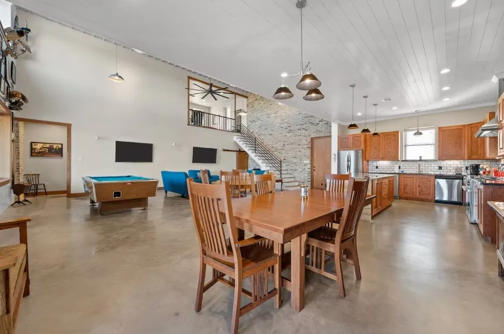 Dining area featuring finished concrete floors, pool table, stairway, and recessed lighting