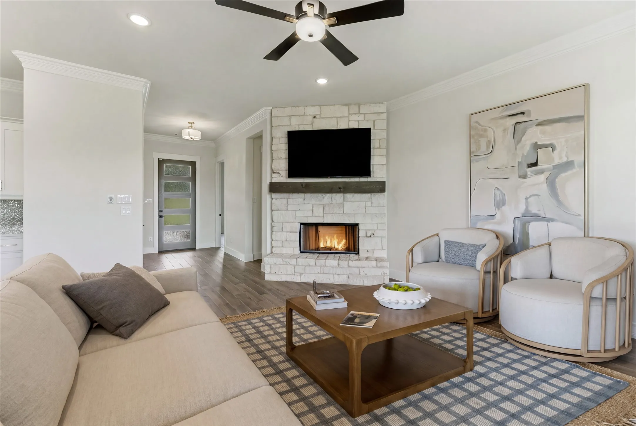 Corner fireplace with stone surround and wood mantel