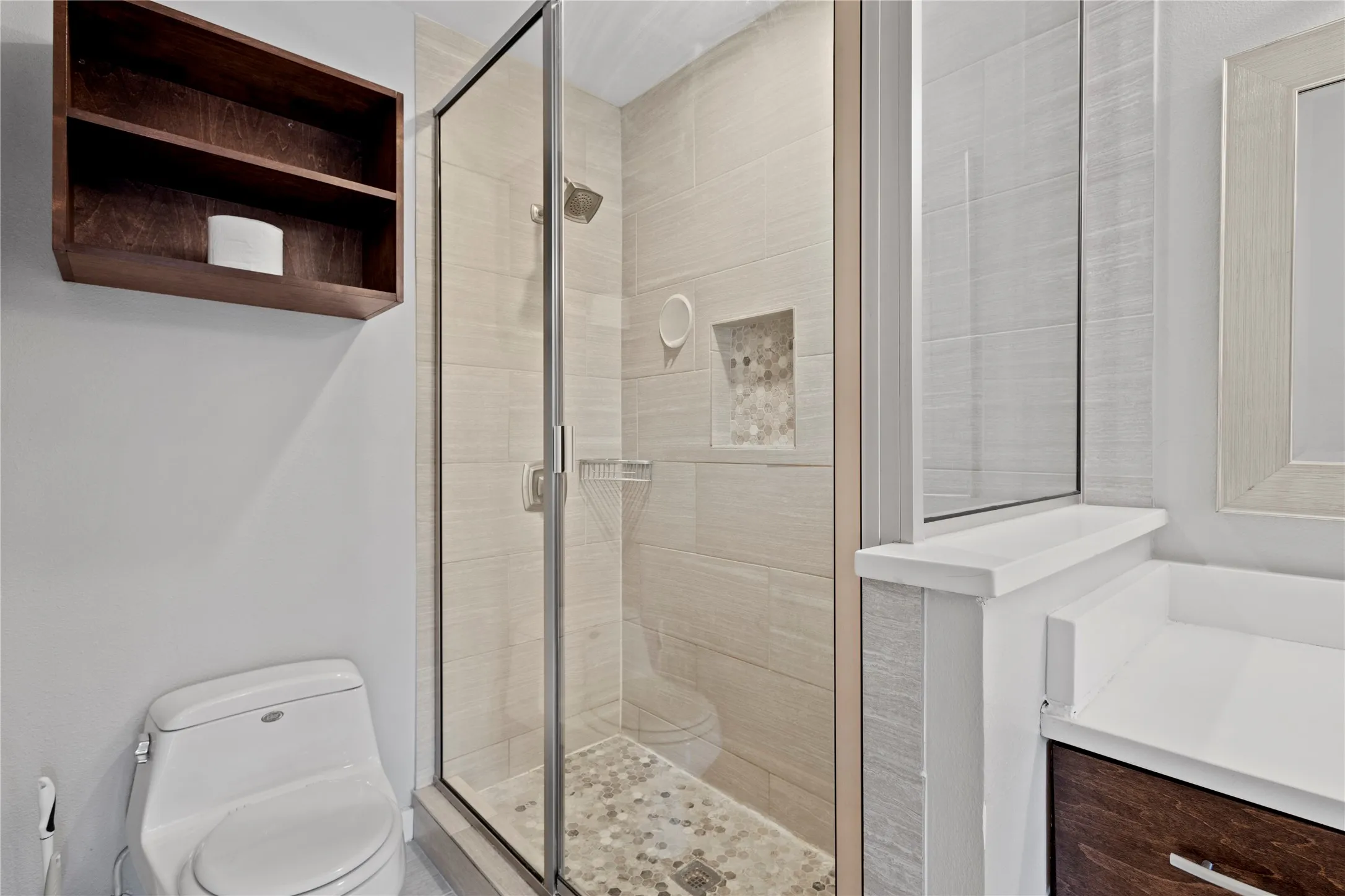 Bathroom with walk in shower, large vanity, and toilet