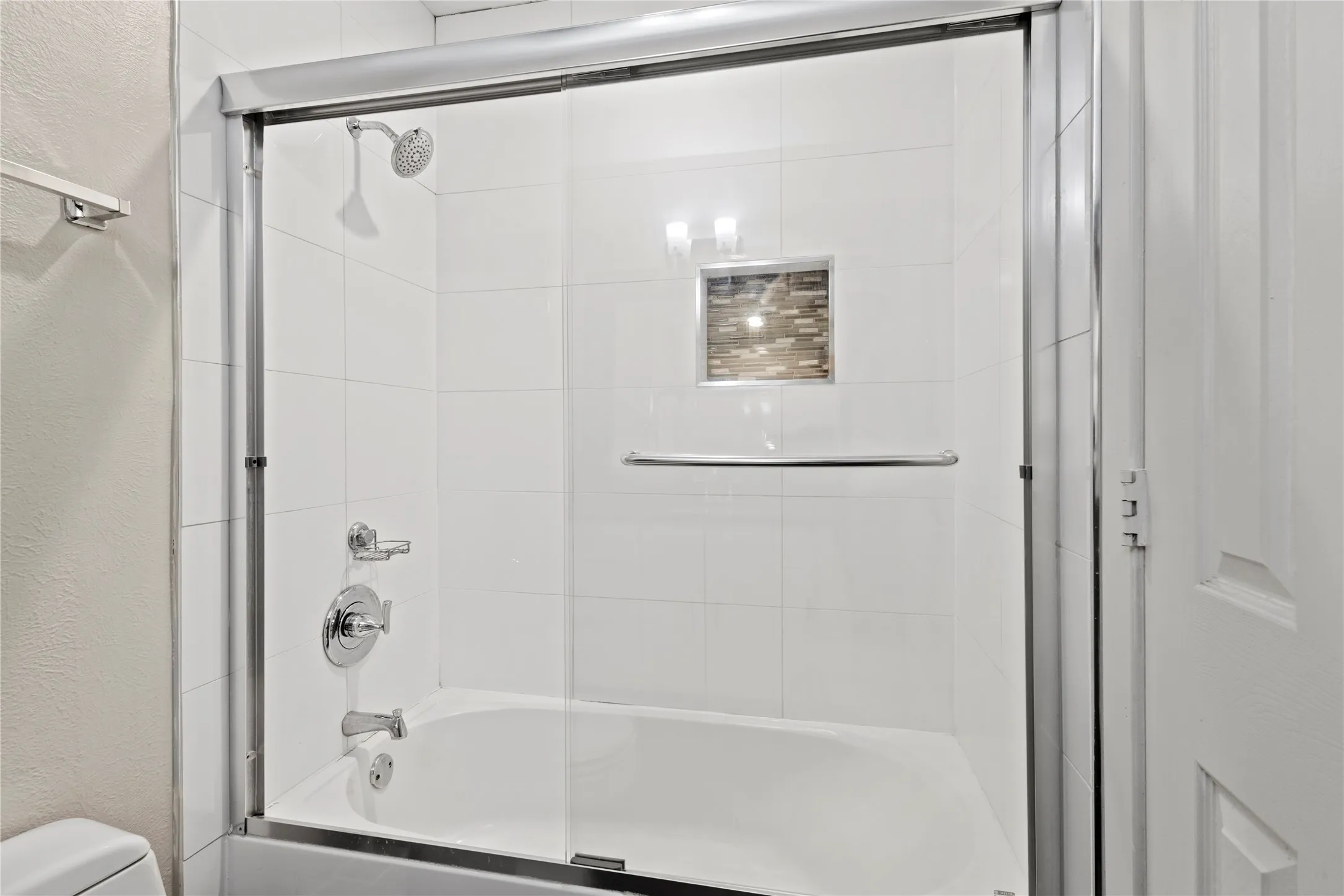 Bathroom with enclosed tub / shower combo and toilet