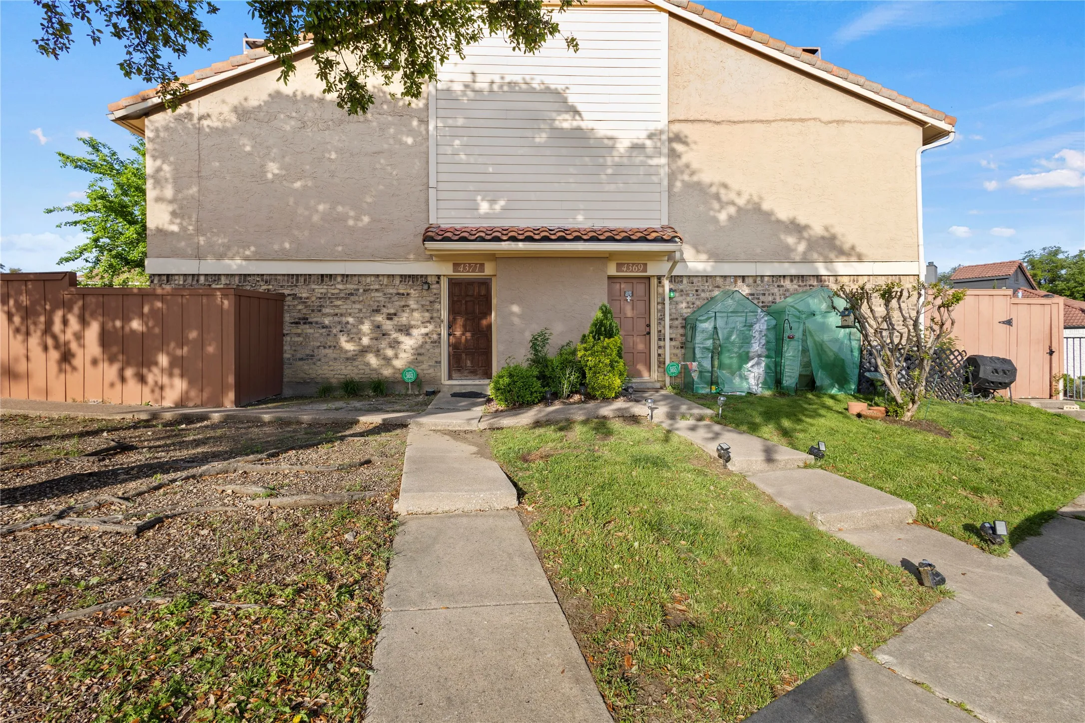 View of front of house with a shed and a front lawn