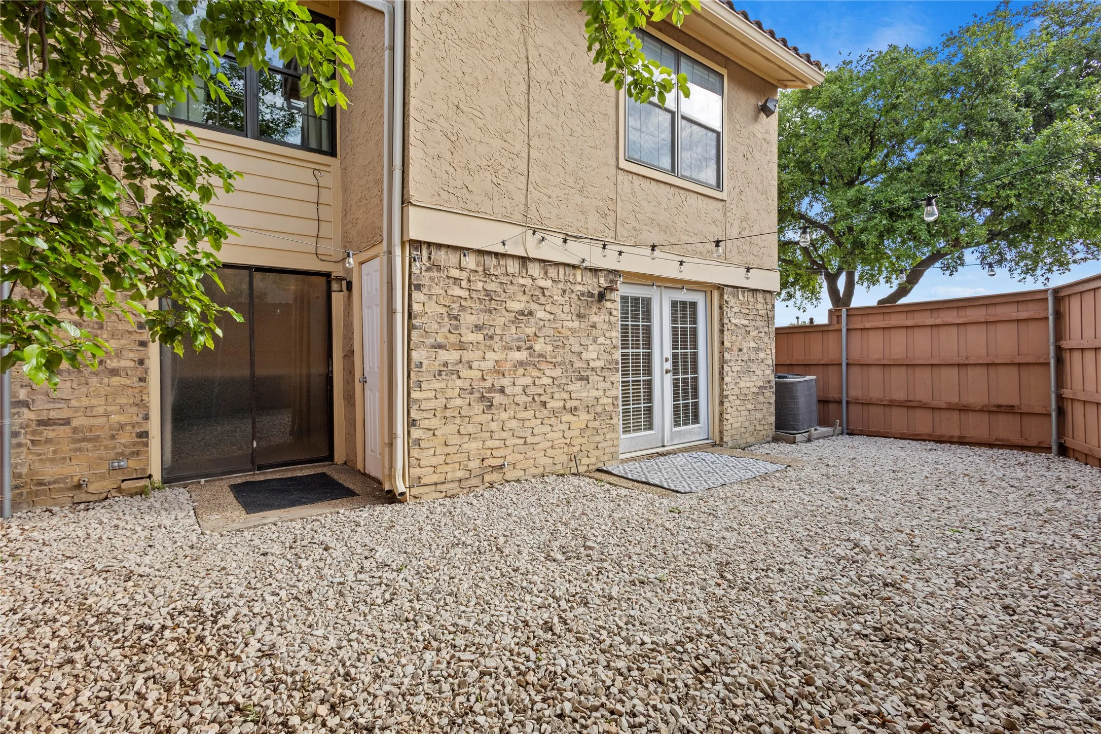 Rear view of property featuring french doors and central AC unit
