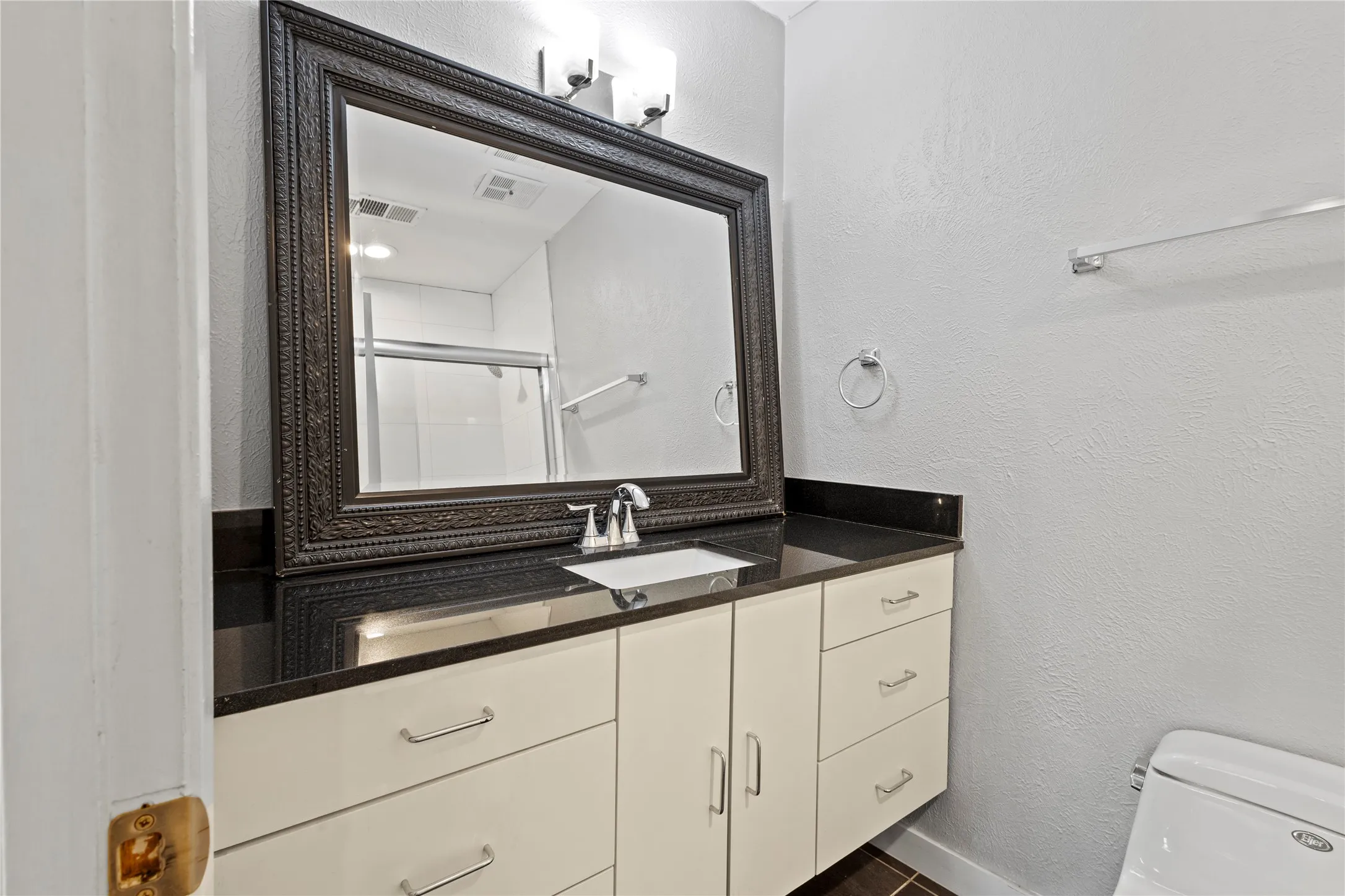 Bathroom with oversized vanity and toilet