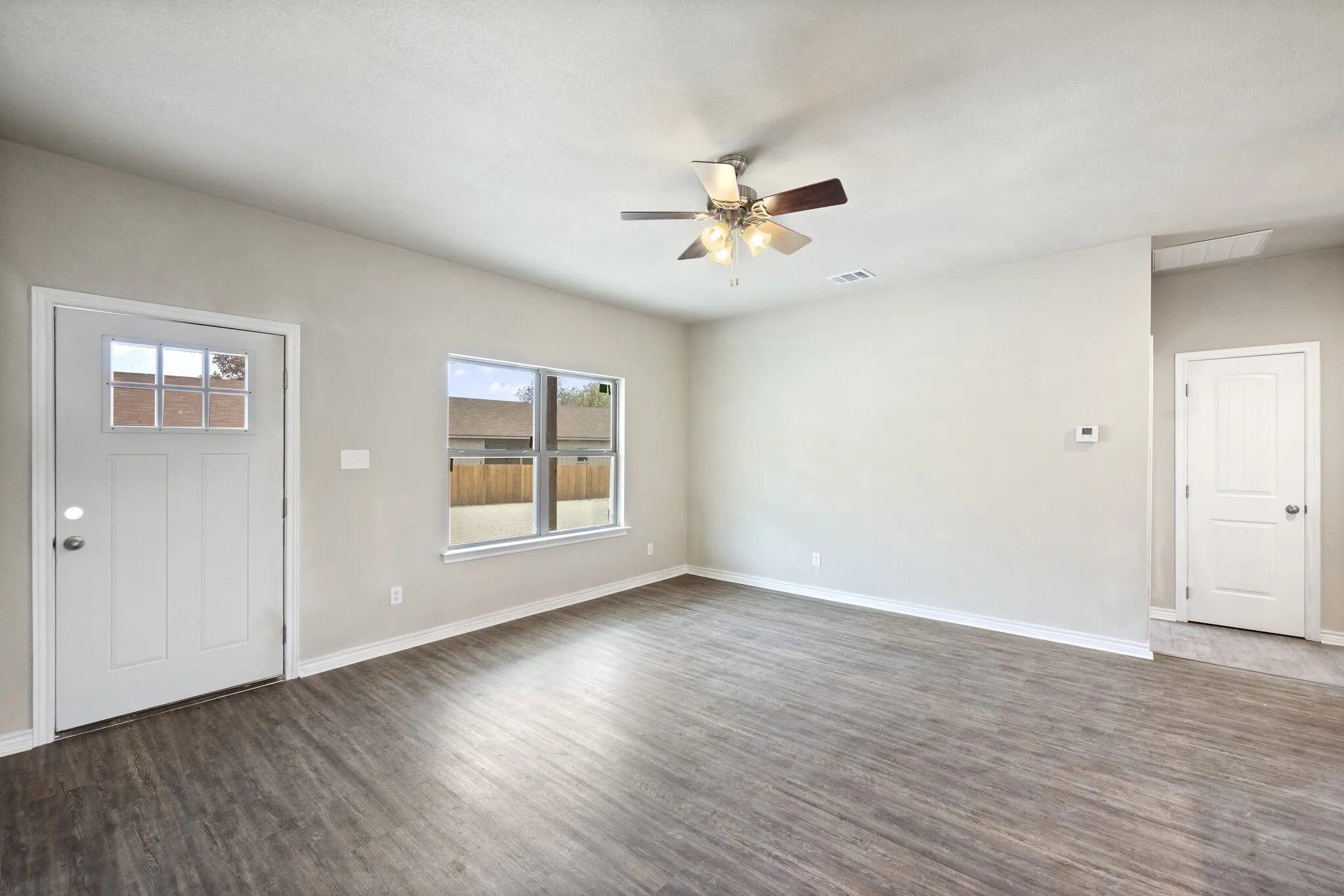Foyer with ceiling fan and dark wood-style flooring