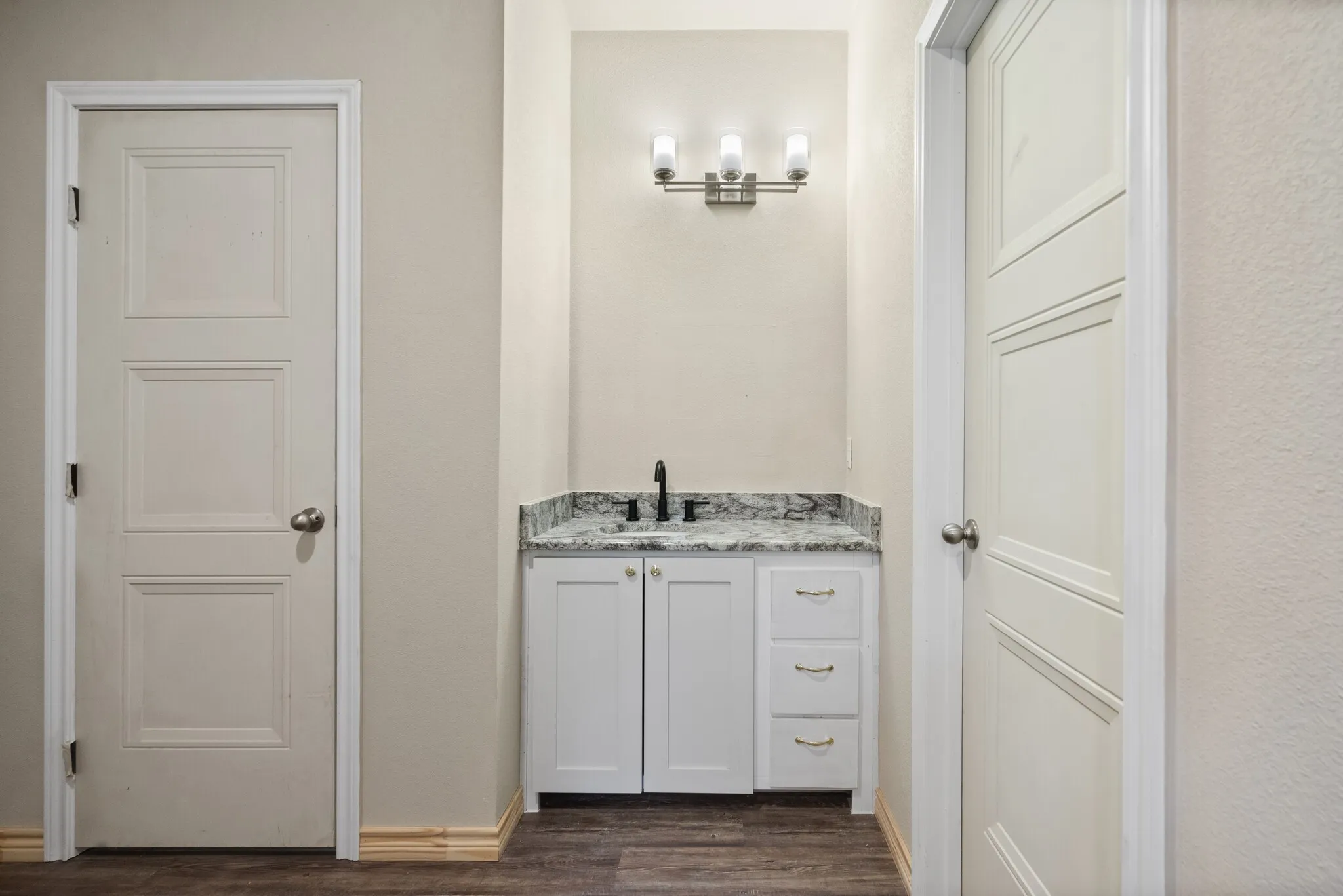 Bathroom featuring vanity and dark wood finished floors