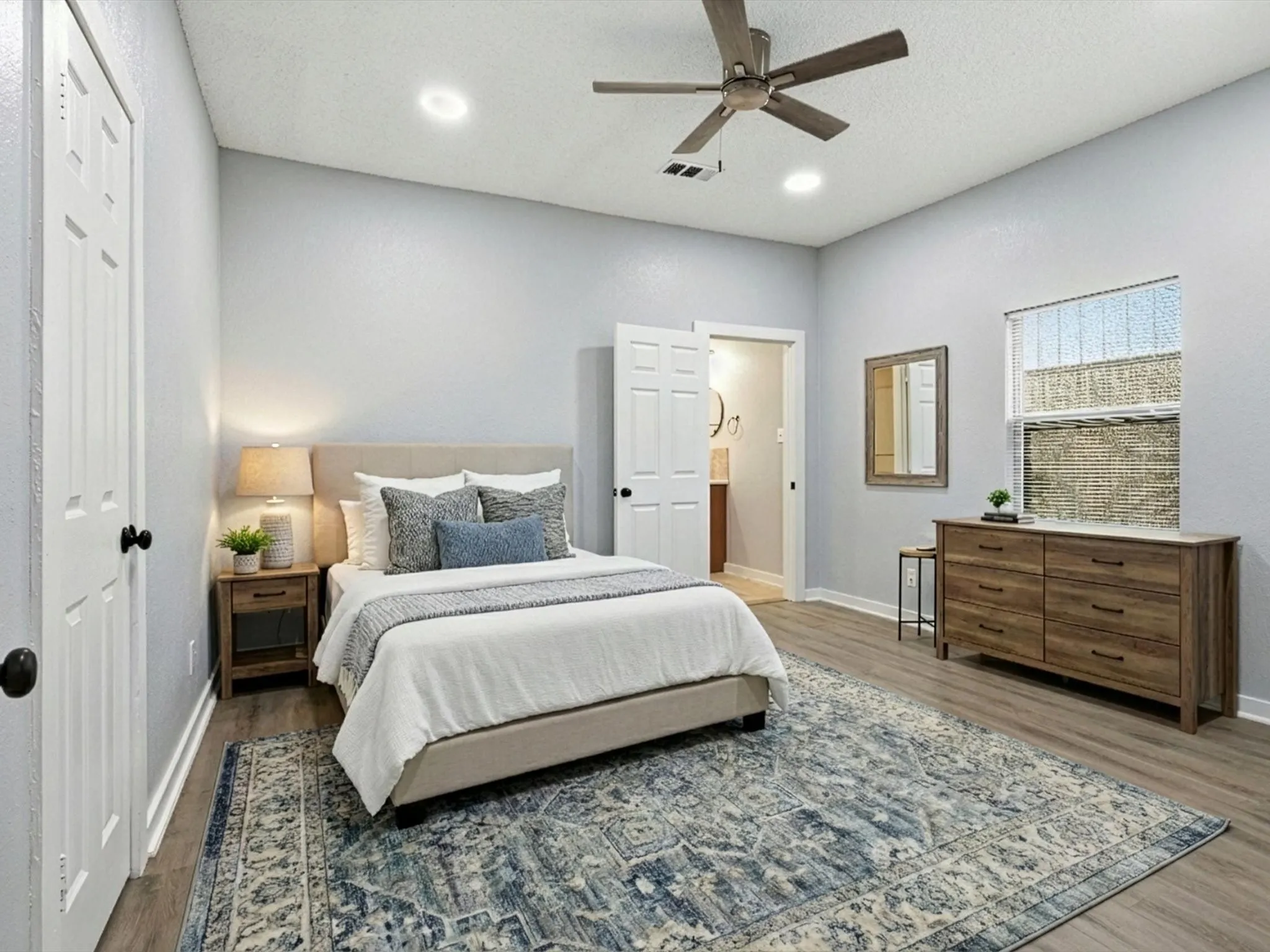Bedroom with ceiling fan, wood finished floors, a textured ceiling, and a closet