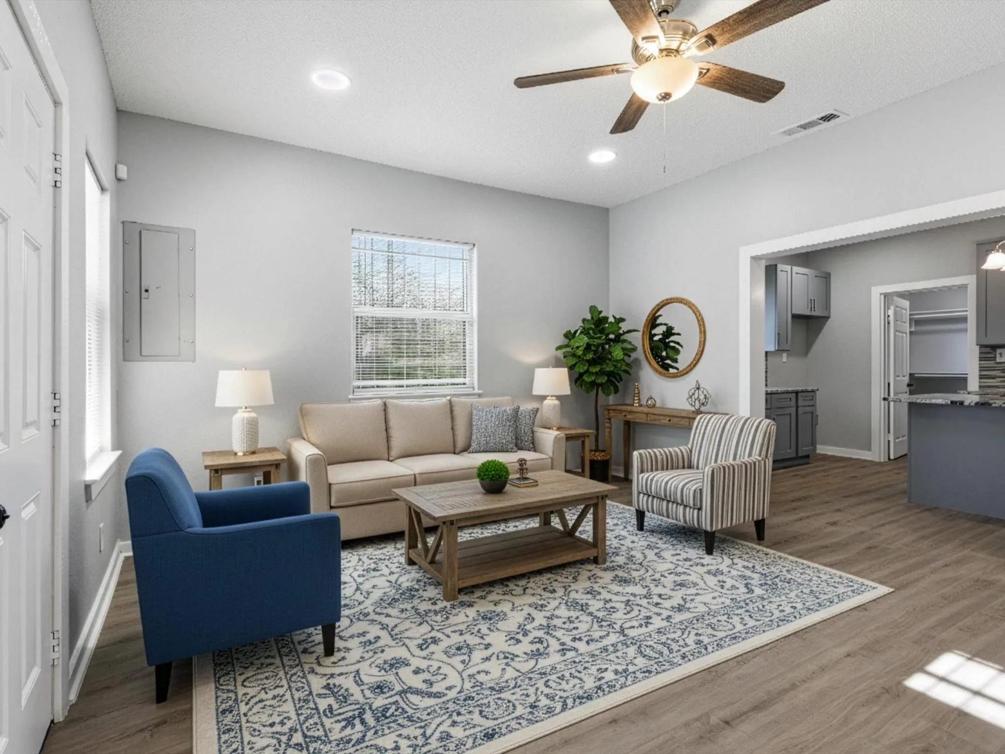 Living room with a ceiling fan, electric panel, wood finished floors, and recessed lighting
