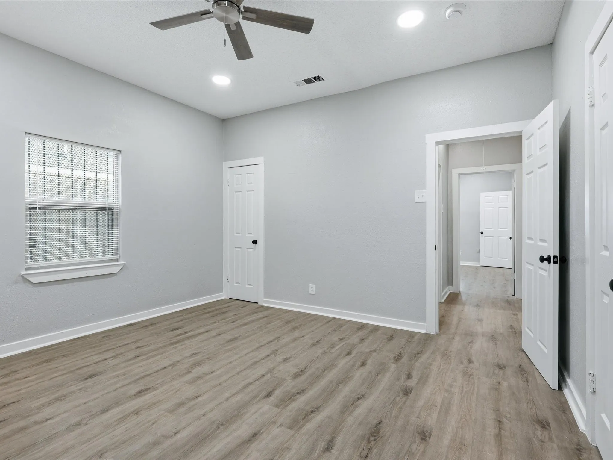 Unfurnished room with ceiling fan, light wood finished floors, and recessed lighting