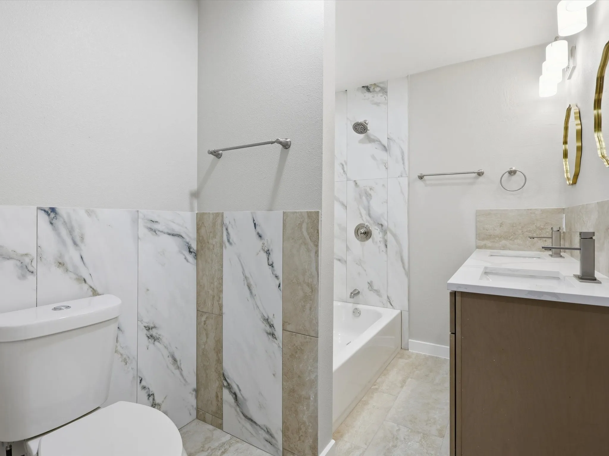 Full bathroom with double vanity and shower / washtub combination