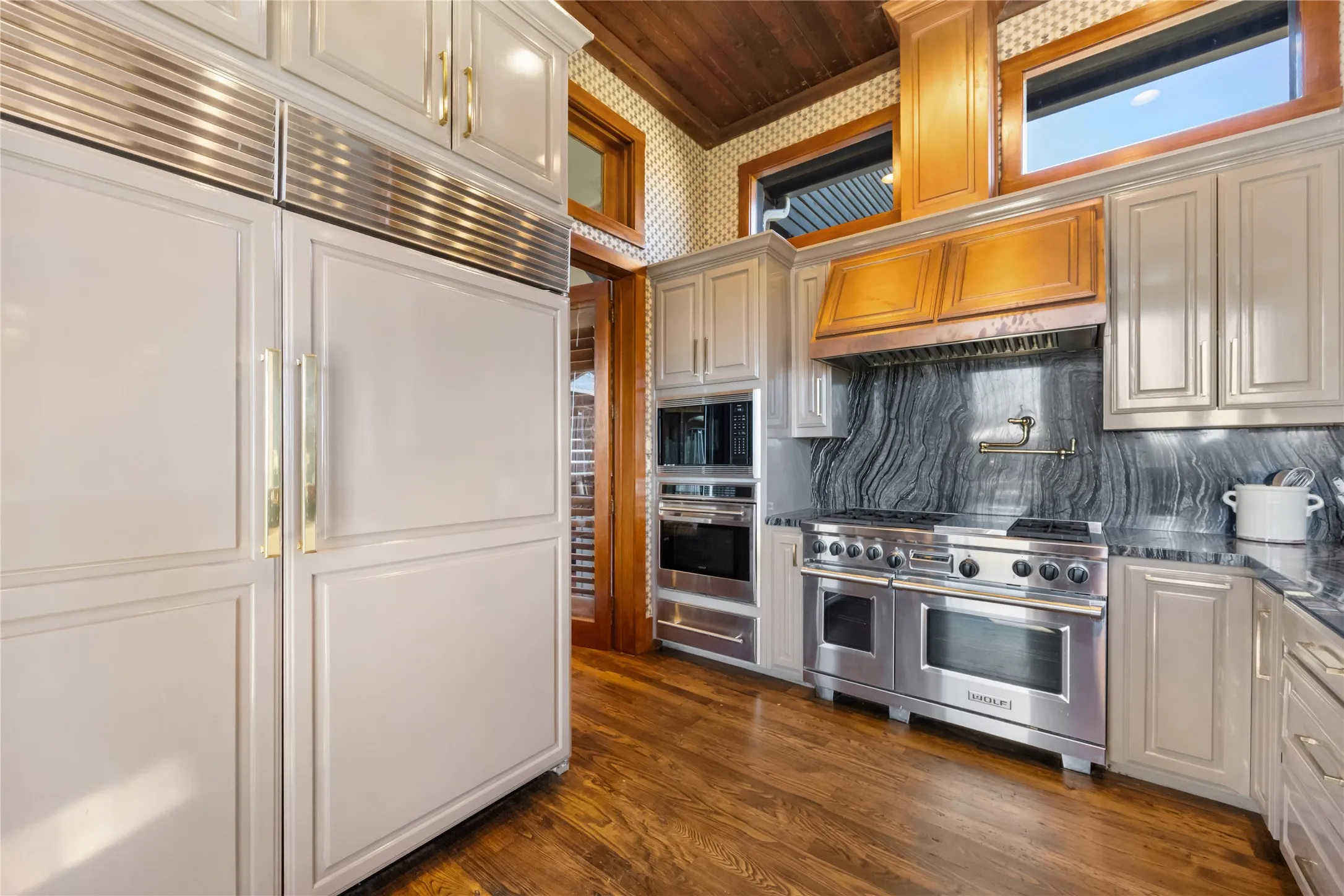 Skullery with Wolf Range Large SubZero Refrig and Freezer, Sink. Windows to the Porch and Outdoors
