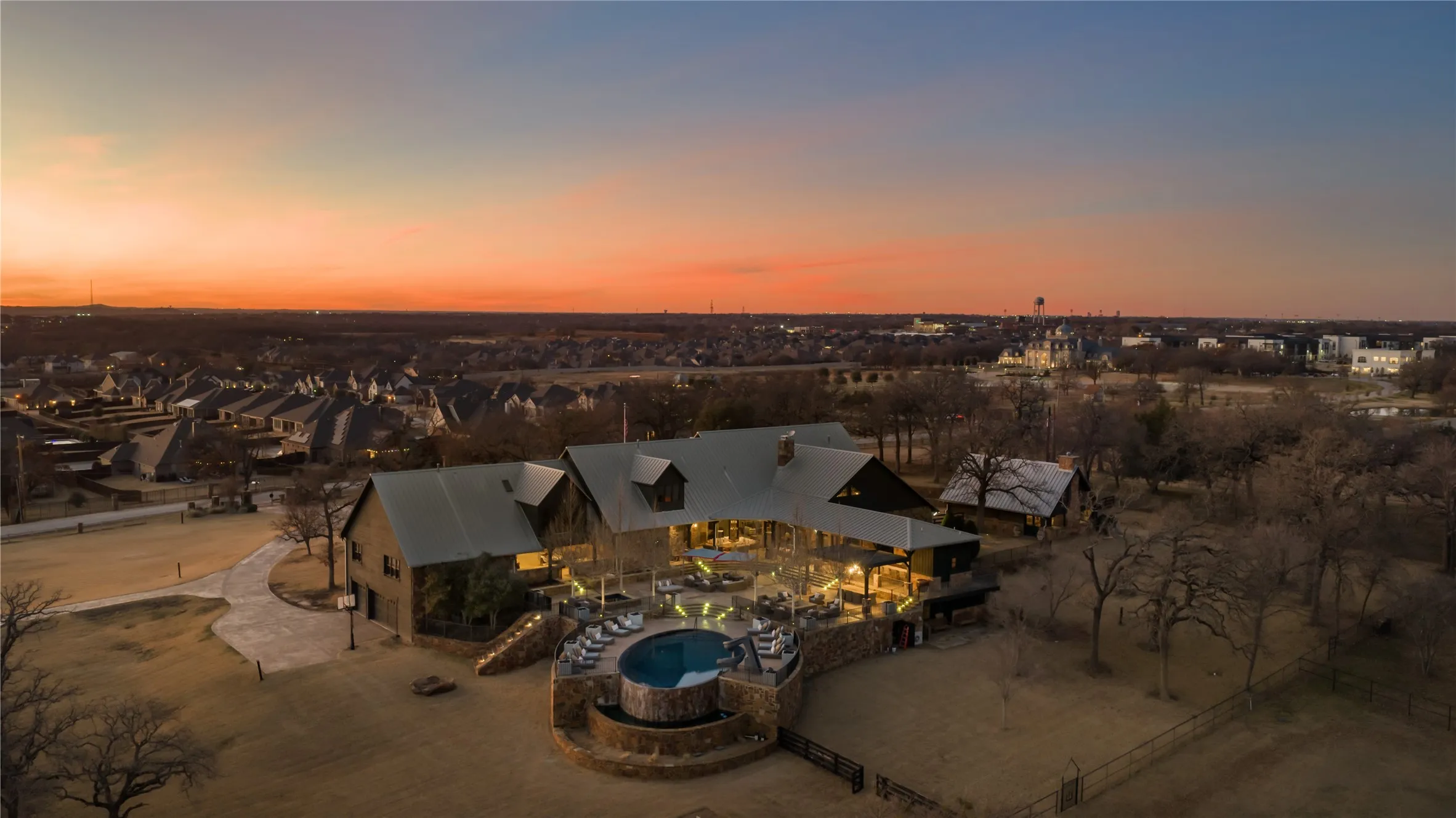 Main House: Rear Elevation. Custom Lamberts Pool (2018) Hot Tub and Water Feature, Covered and Open Porches, Outdoor Kitchen and Bar, 2 Outdoor Firepits