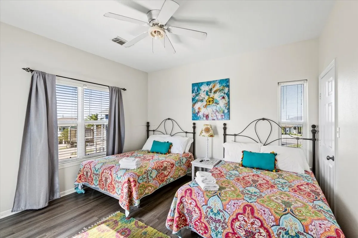 Bedroom featuring ceiling fan and dark hardwood / wood-style flooring