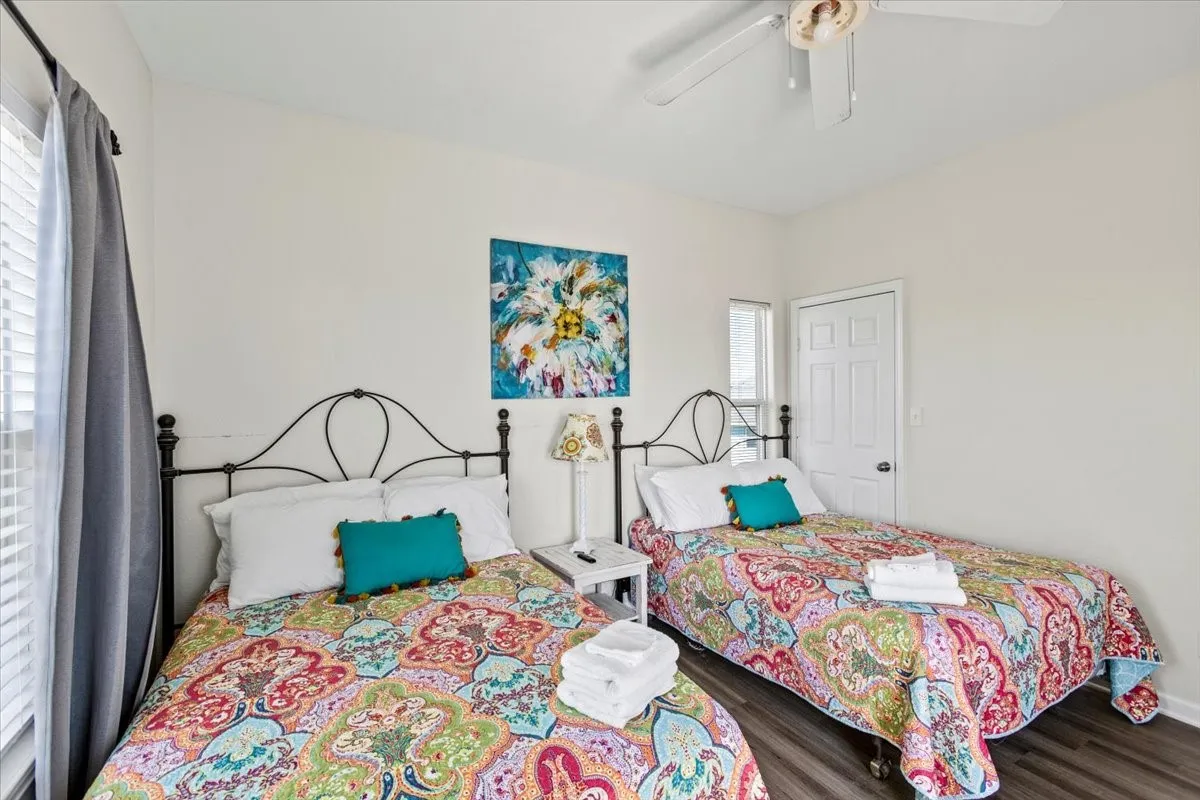 Bedroom featuring ceiling fan and dark wood-type flooring